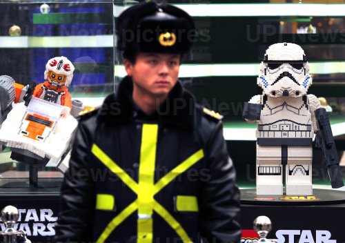 A Chinese security guard stands in front of a Star Wars Lego display in Beijing