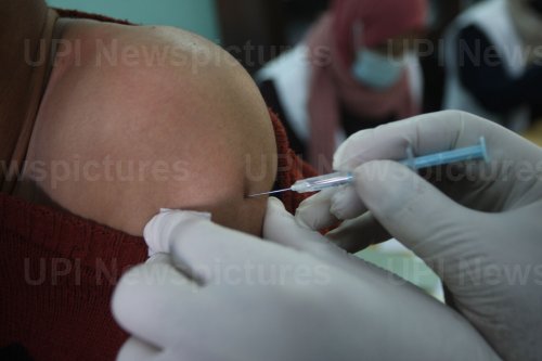 Health Workers Inoculate Students With a Dose of The Covid-19